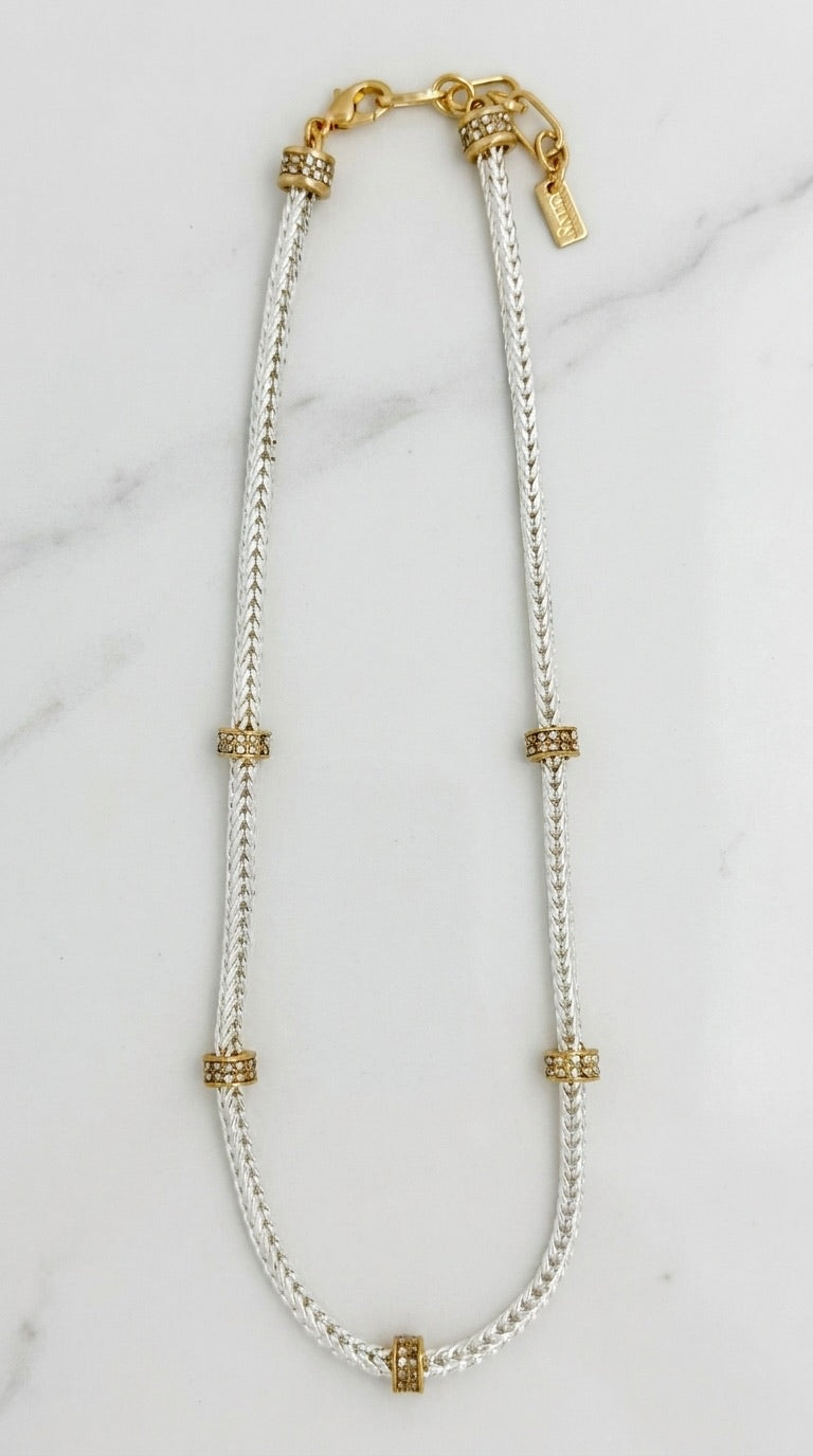 Envy silver herringbone mesh chain necklace with five gold pavé crystal rondelle spacers on marble background