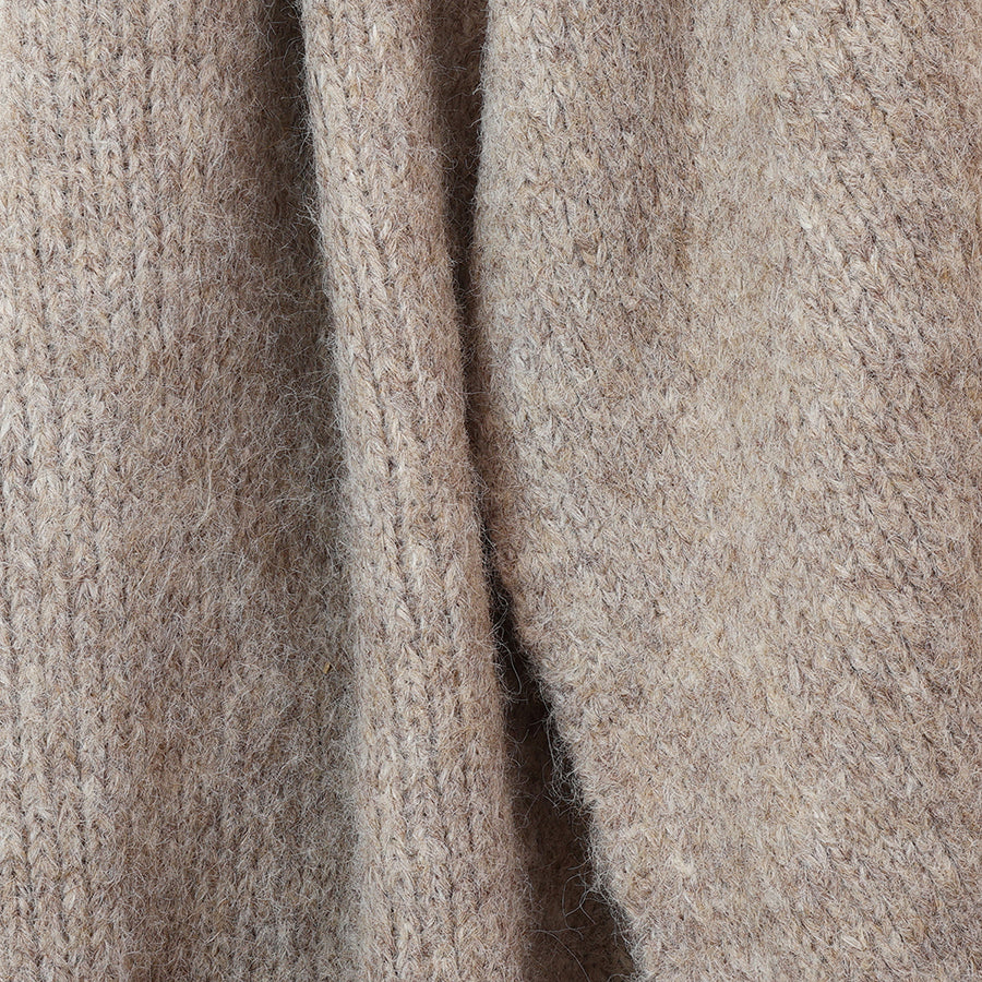 Close-up of the POM Ashleigh oatmeal marl chunky knit scarf fabric, showing the soft fluffy ribbed knit texture in warm neutral tones.