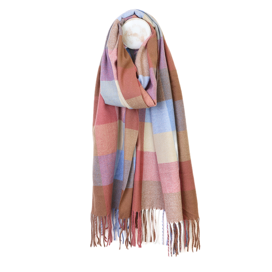 POM Esme blush and blue mix check scarf draped on a mannequin stand against a white background, showing the oversized block check in blush, dusky rose, periwinkle blue, lilac, camel and cream with mixed multicolour fringe ends.