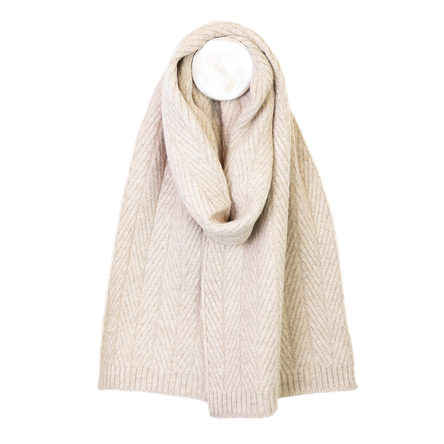 POM Charlotte oatmeal herringbone knit scarf looped around a mannequin, showing the ribbed ends and soft textured weave against a white background.