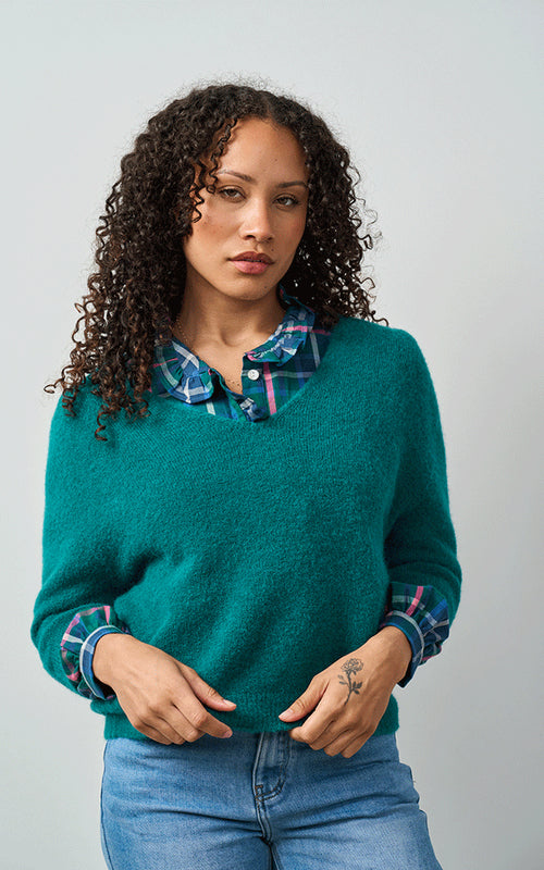 Woman wearing Luella Valentina teal alpaca short-sleeve V-neck knit jumper with blue jeans