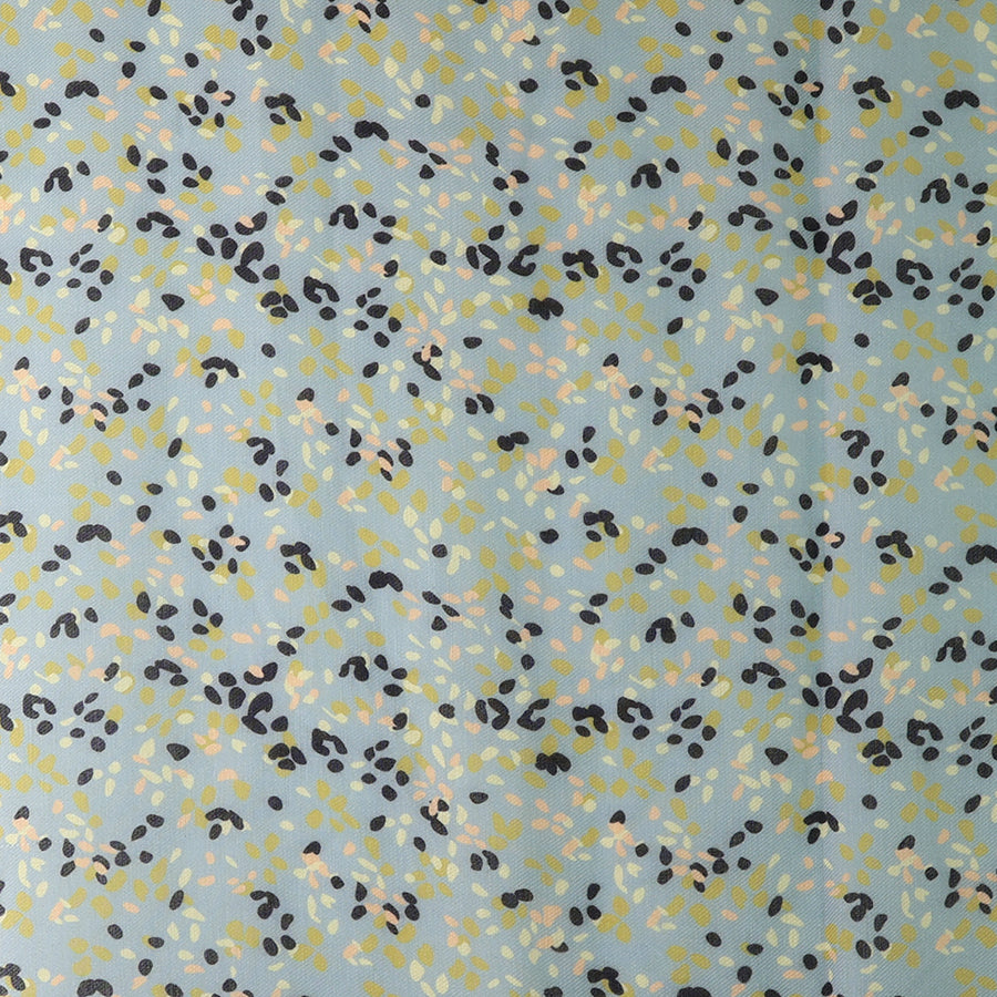 Close-up of the POM pale mint green ditsy print scarf fabric, showing the scattered navy, yellow-green and blush small leaf print on the soft pale mint ground.