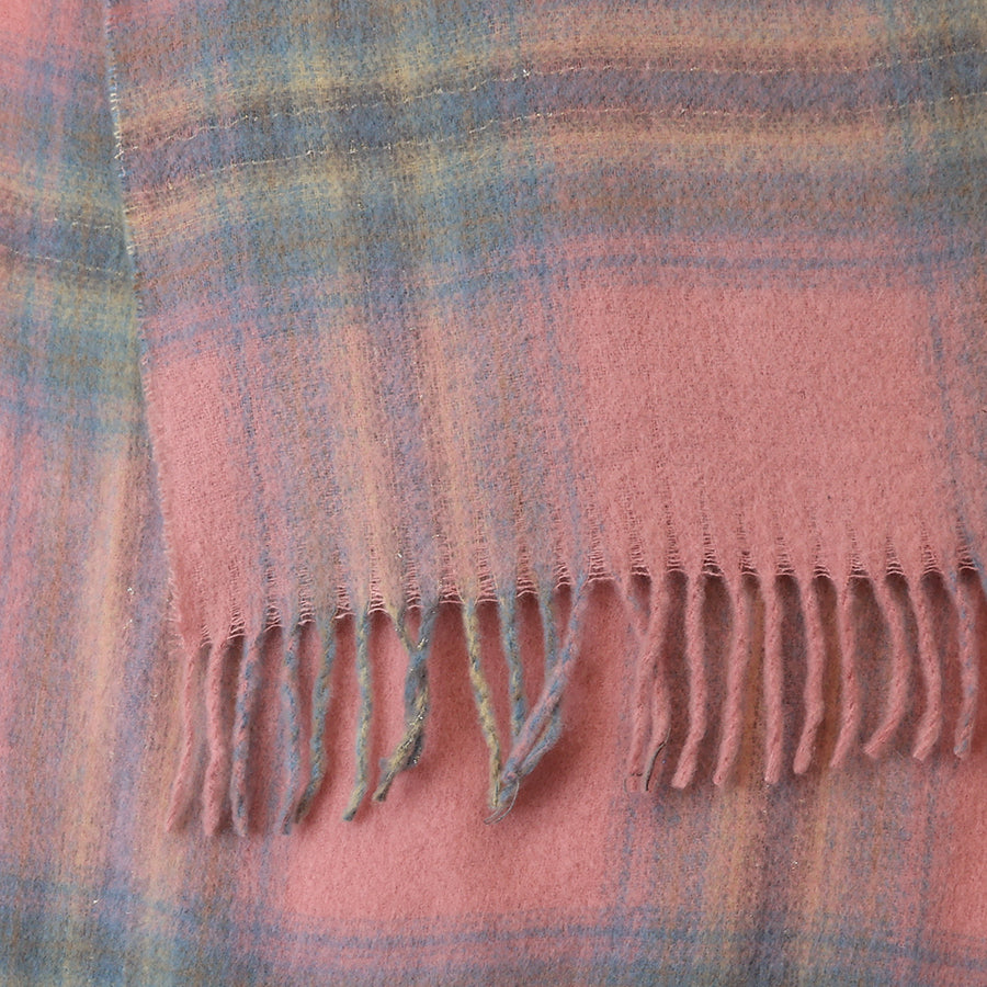 Close-up of the POM Miranda pastel pink, blue and grey mix scarf fabric, showing the oversized pastel check in blush pink, dusty blue, sage green and warm yellow with a soft blended finish and twisted fringe ends at the bottom edge.