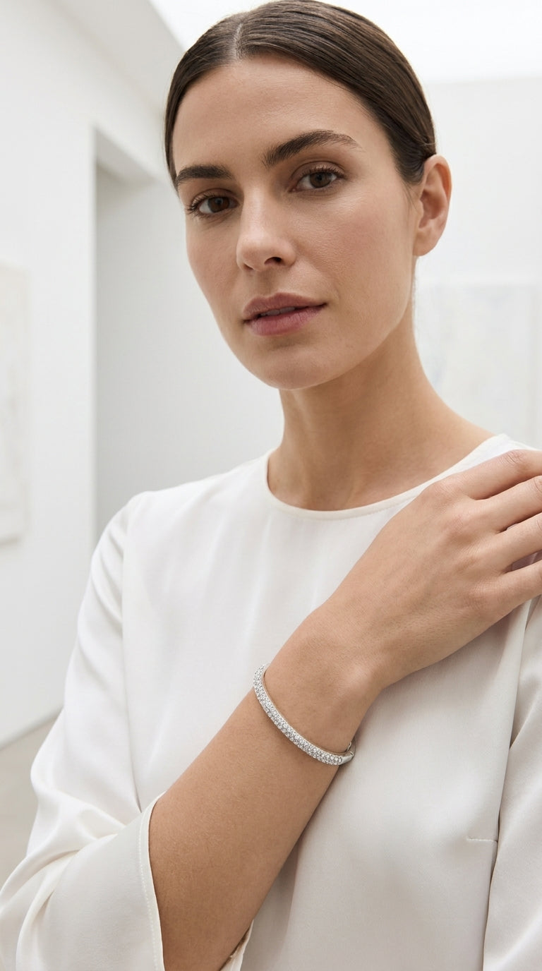 Model wearing Envy silver double row pavé crystal hinged bangle with white long sleeve top