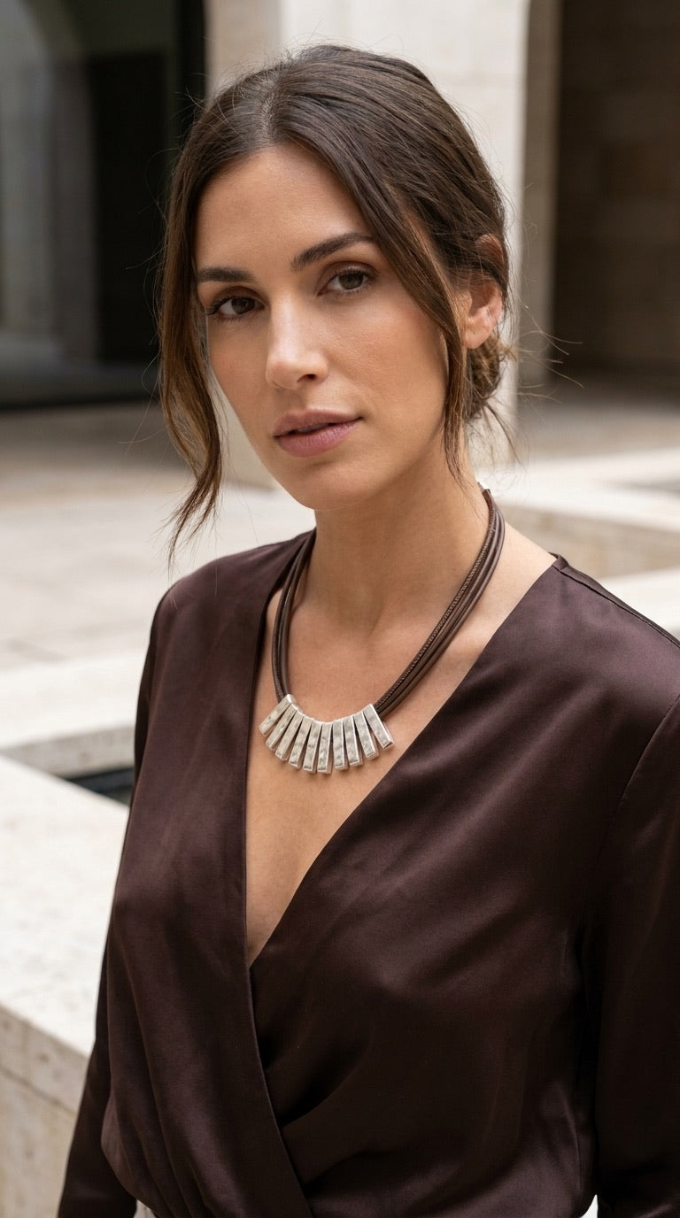Model wearing Envy silver hammered bar tube bib necklace with deep brown satin wrap top