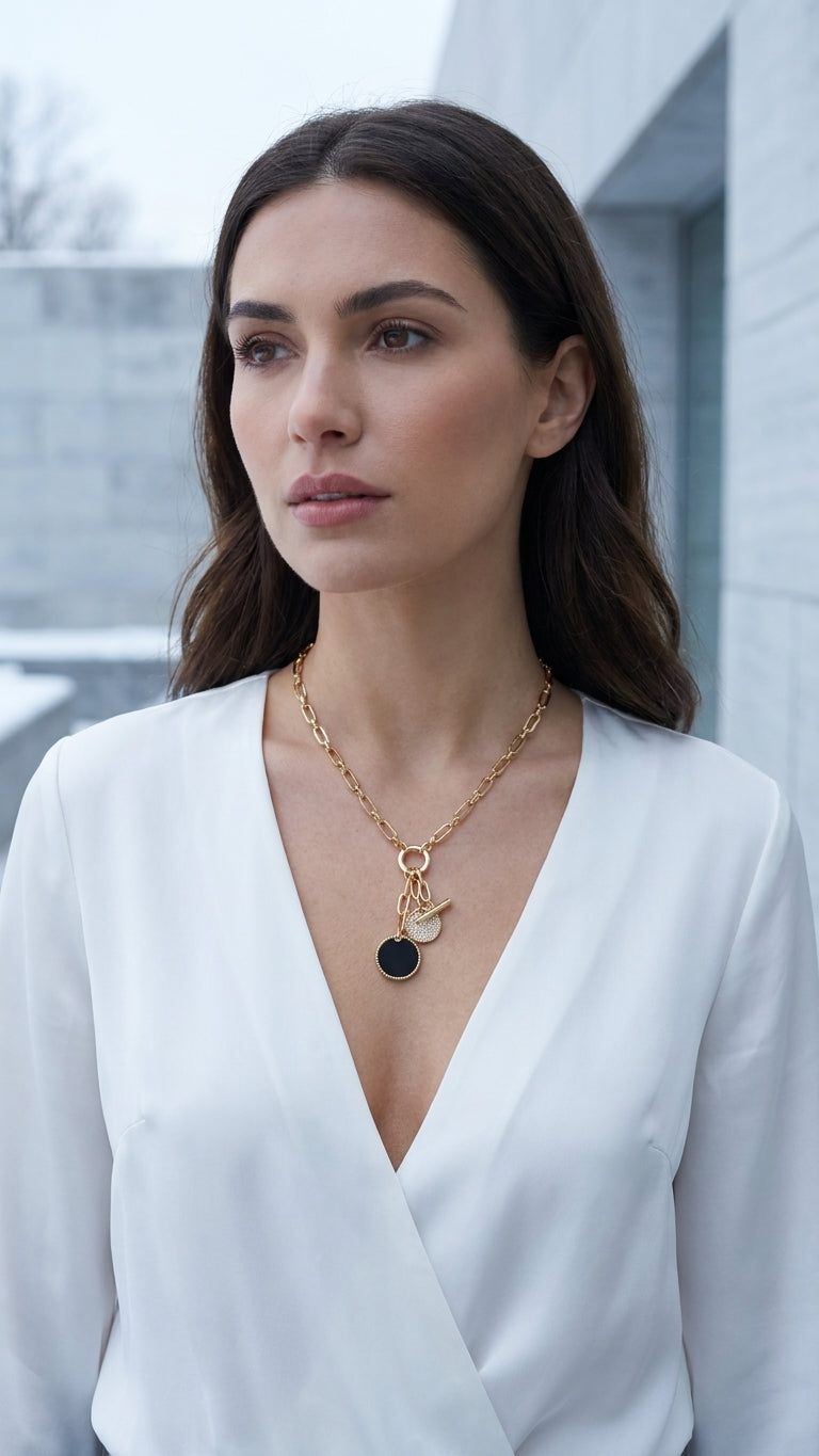 Model wearing Envy mixed link triple charm necklace with white v-neck blouse.