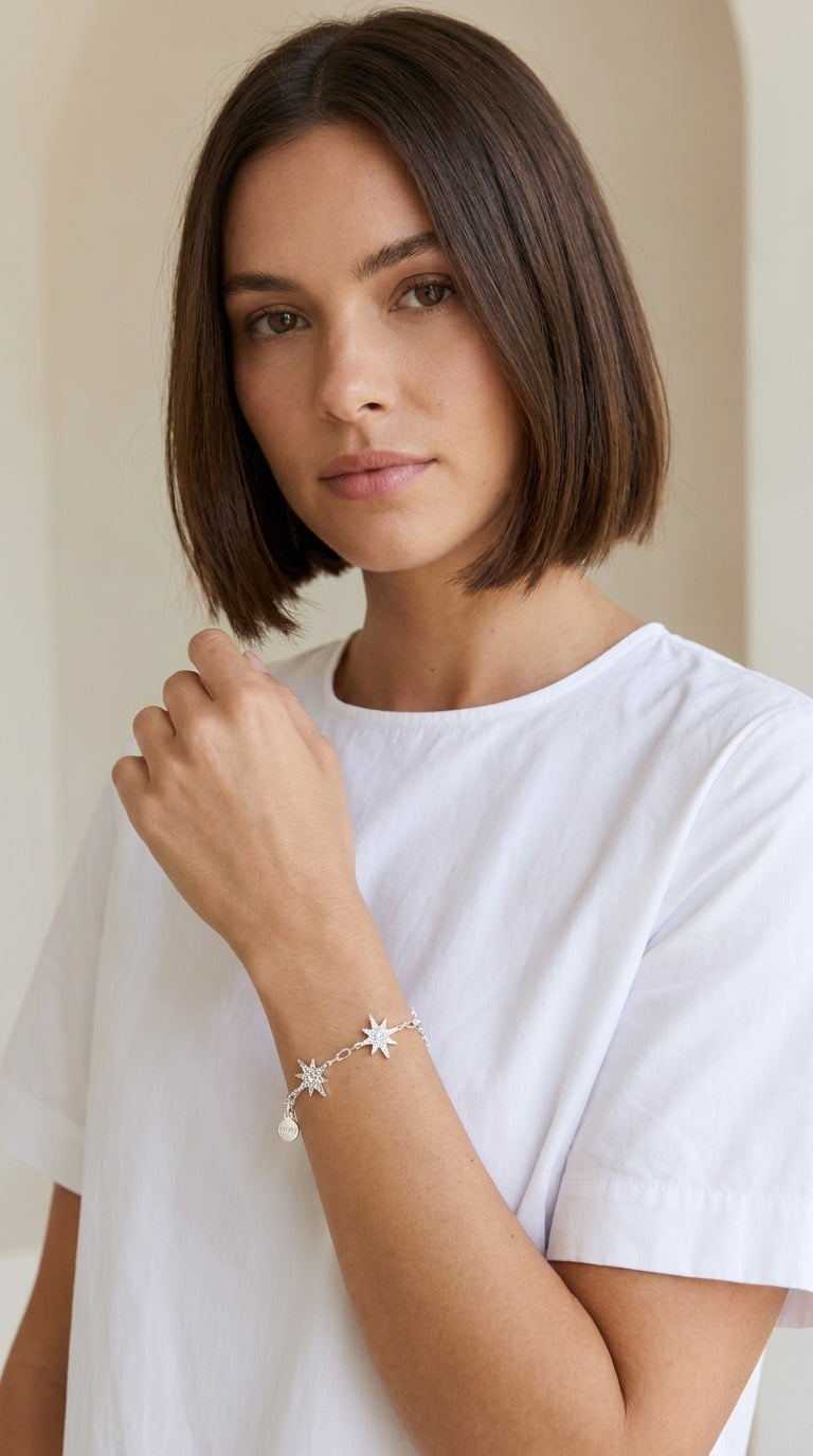 Model wearing Envy silver pavé crystal star charm bracelet with T-bar toggle with white t-shirt