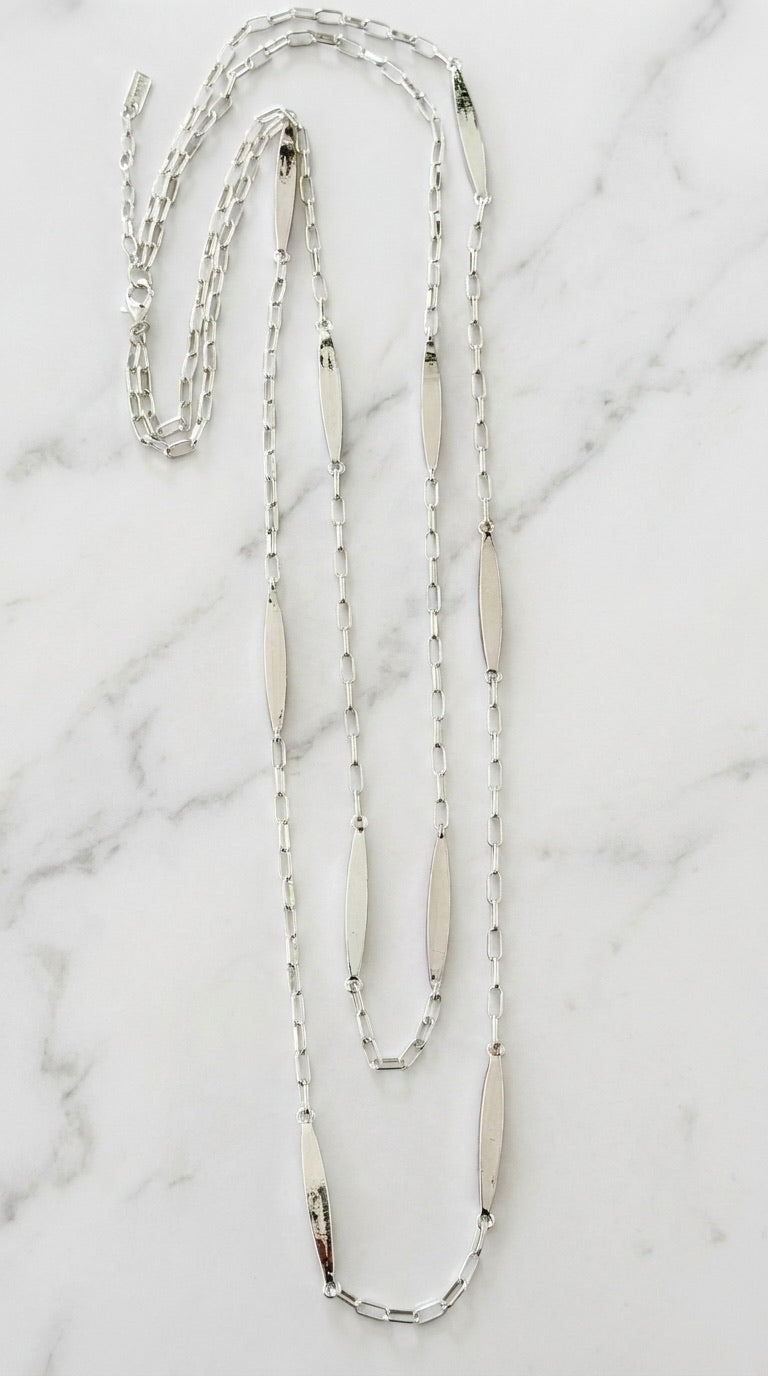 Envy silver long double layer chain necklace with oval bar links on marble background