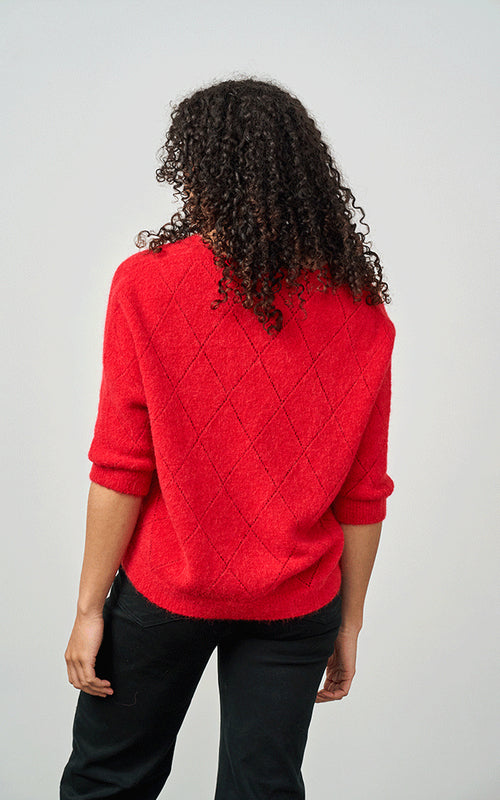 Woman wearing Luella Montrose short-sleeve red alpaca diamond pattern V-neck knit jumper