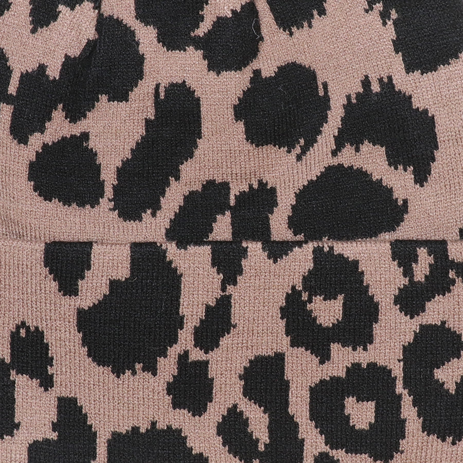 Close-up of the POM Carly leopard print beanie knit fabric, showing the bold taupe and black animal print pattern and fine knit texture.