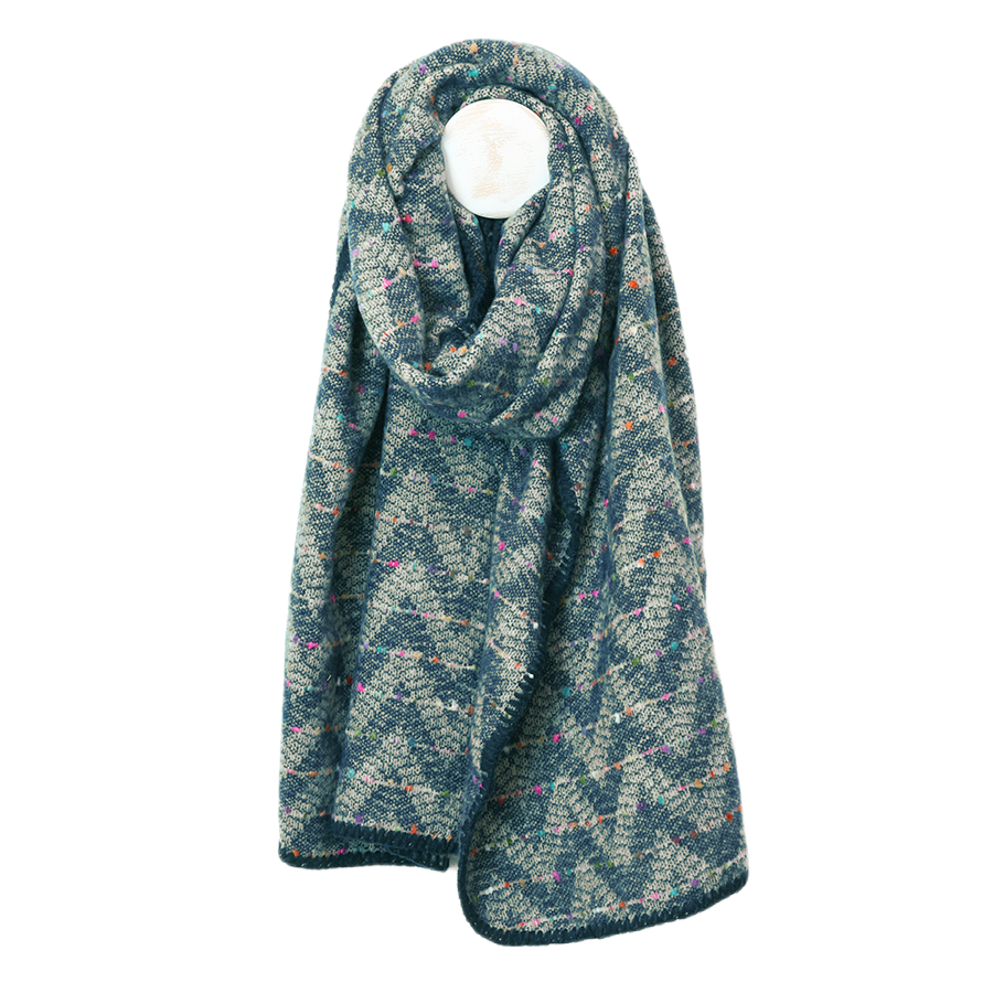 POM Tara teal mix chevron weave confetti fleck blanket wrap looped on a mannequin stand against a white background, showing the teal and ecru chevron weave with scattered multicolour confetti fleck and navy blanket stitch edge.