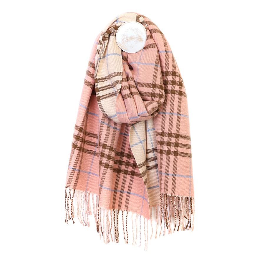 POM Nellie salmon pink, blue and brown mix check scarf looped on a mannequin stand against a white background, showing the classic salmon pink and ecru check with brown grid lines, pale blue accent stripes and twisted fringe ends.