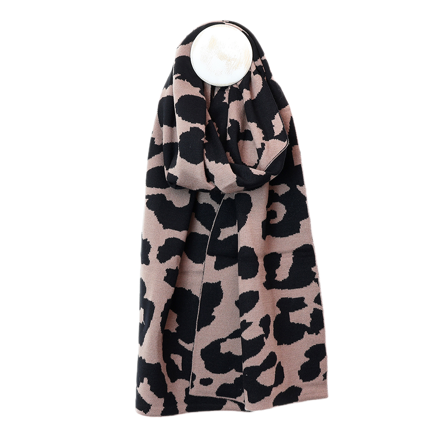 POM Carly taupe and black animal print knitted scarf draped around a mannequin, showing the bold leopard print pattern and generous length against a white background.