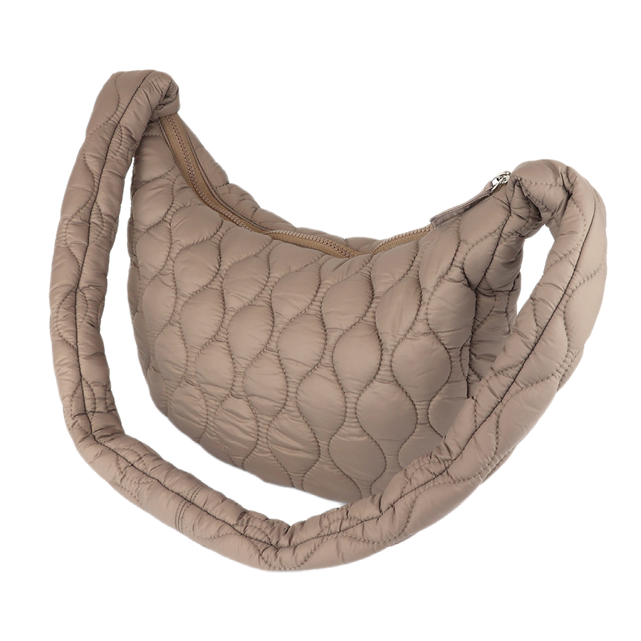 POM Polly beige quilted half moon bag with bubble quilt pattern, padded shoulder strap and gold zip closure, shown against a white background.