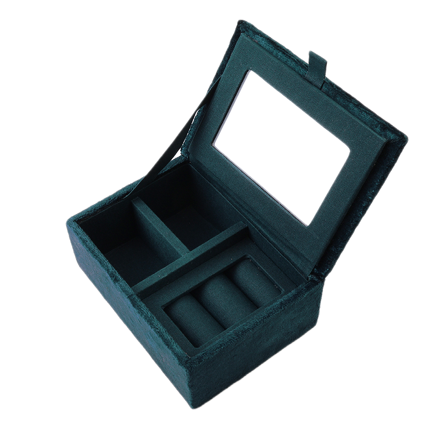 POM Crane teal velvet jewellery box shown open, revealing a mirror inside the lid, teal velvet ring rolls and compartments for storing jewellery, against a white background.