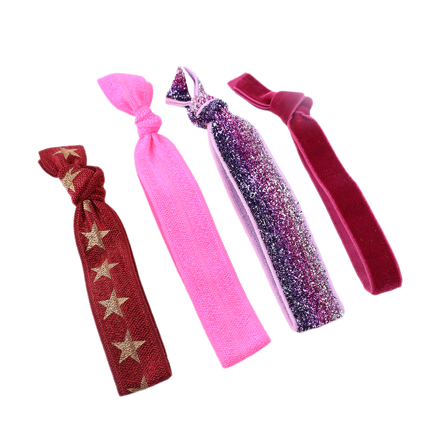 POM set of four fold-over elastic hair ties in red and gold star print, hot pink, purple and pink glitter ombré, and deep burgundy velvet, shown flat against a white background.