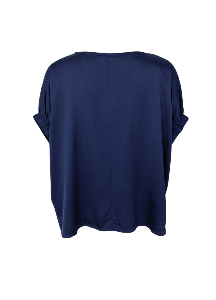 A navy blue short-sleeve top shown from the back, featuring a relaxed silhouette and a subtle vertical seam down the center back, displayed on a clean white background.